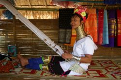 A long-necked tribe woman is weaving in a Patai village - Highlights of Thailand tour