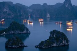 Ha Long Bay lit up at night by Hanoi Voyages