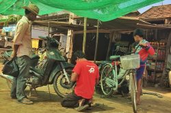 Local Cambodian fixing their motorbikes