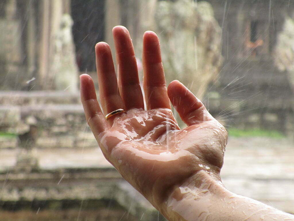 Hand catching rain in Myanmar - Best time to visit Myanmar
