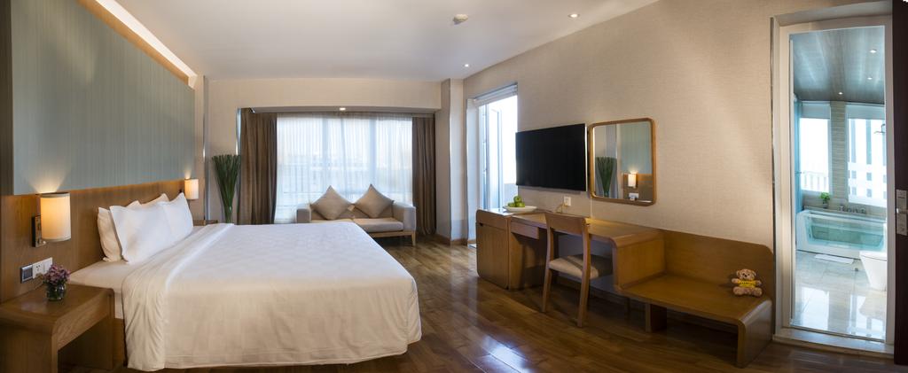 harmony saigon hotel - premier deluxe room with seating area