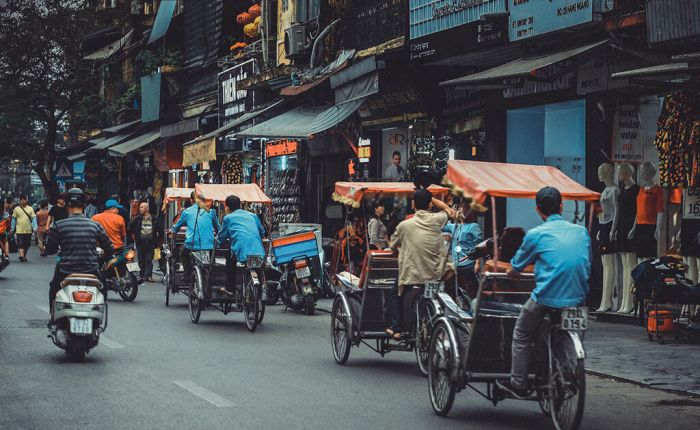 Traditional Vietnamese bicycle rickshaws navigating the busy streets of Hanoi