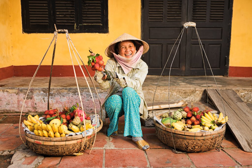 A woman sells fruit in Vietnam